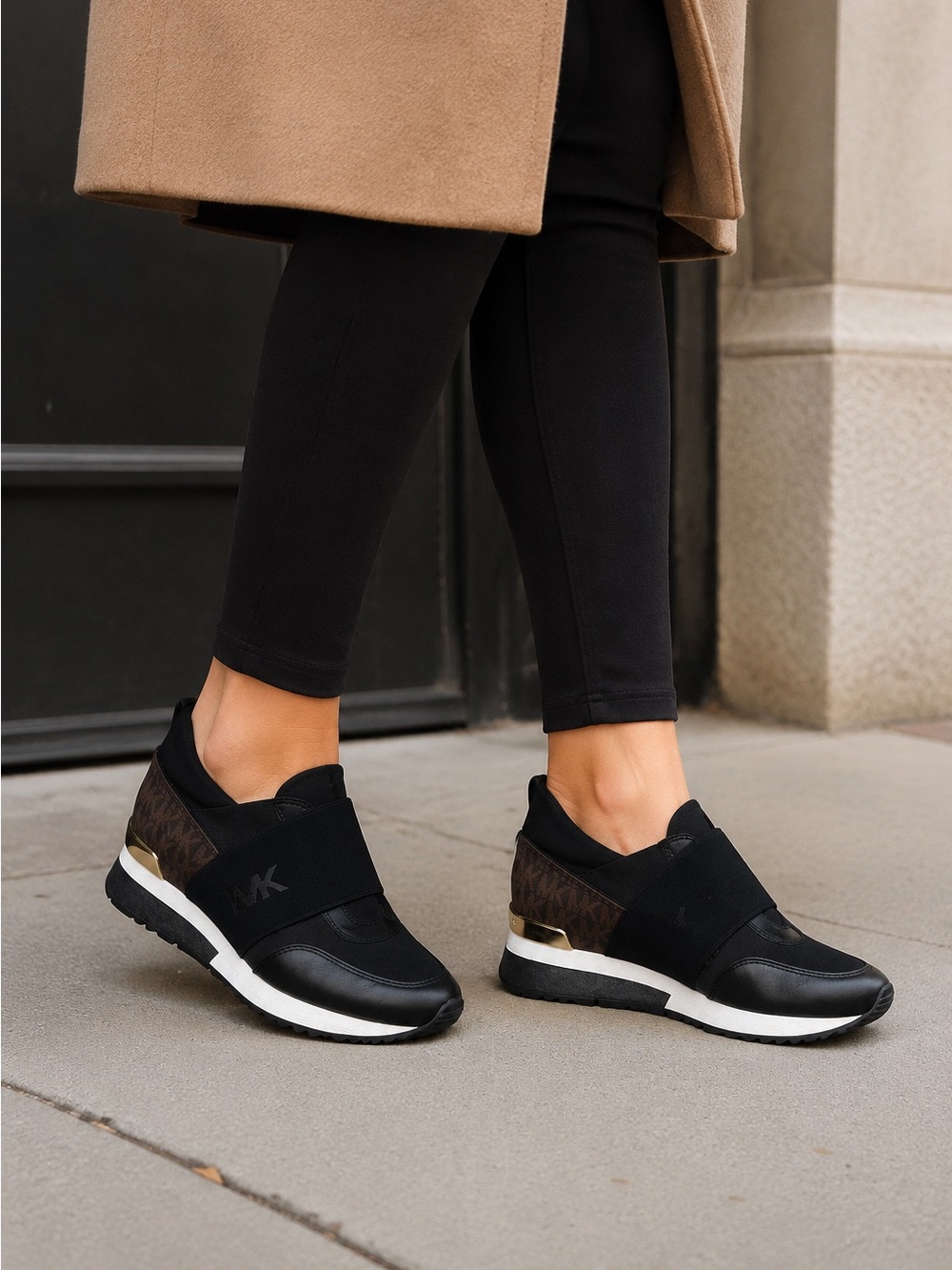 Michael Kors black slip-on wedge sneakers in women’s size [7.5].